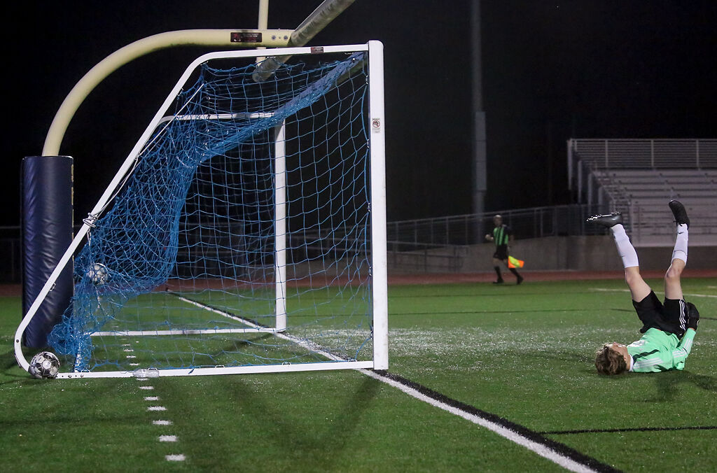 Battle junior goalkeeper Payson Davenport lies on his back